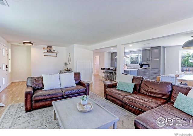 11230 W 77th Dr, Arvada, CO 80005 - living room featuring light wood-style flooring and recessed lighting