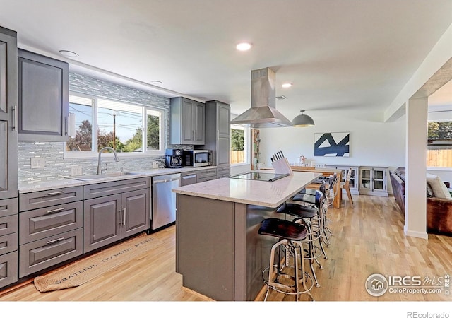 11230 W 77th Dr, Arvada, CO 80005 - kitchen with island range hood, gray cabinets, appliances with stainless steel finishes, a center island, and recessed lighting