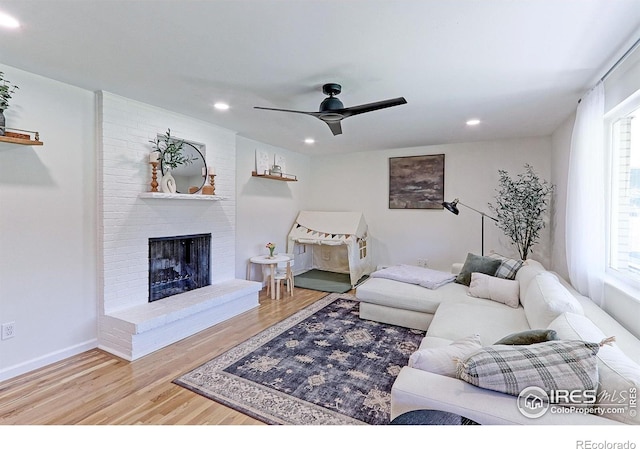 11230 W 77th Dr, Arvada, CO 80005 - living area featuring wood finished floors, recessed lighting, plenty of natural light, a brick fireplace, and ceiling fan