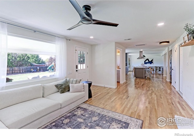 11230 W 77th Dr, Arvada, CO 80005 - living room with light wood-type flooring, ceiling fan, and recessed lighting