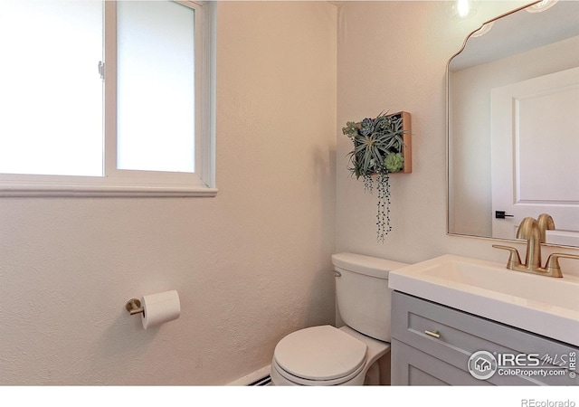 11230 W 77th Dr, Arvada, CO 80005 - half bathroom featuring vanity and toilet