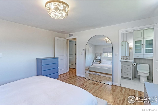 11230 W 77th Dr, Arvada, CO 80005 - bedroom with wood finished floors and a chandelier