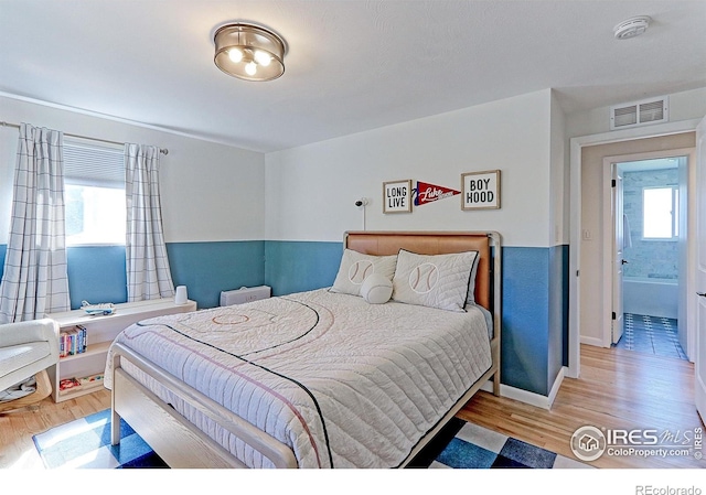 11230 W 77th Dr, Arvada, CO 80005 - bedroom featuring wood finished floors and baseboards