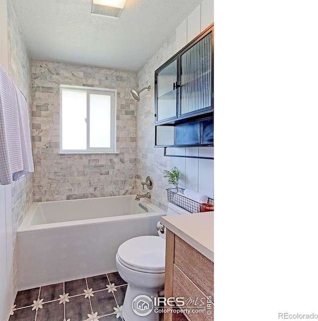 11230 W 77th Dr, Arvada, CO 80005 - full bath with vanity, tub / shower combination, tile patterned floors, and a textured ceiling
