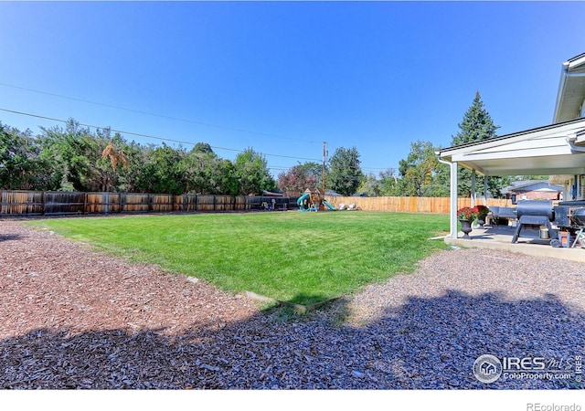 11230 W 77th Dr, Arvada, CO 80005 - fenced backyard with a playground and a patio area
