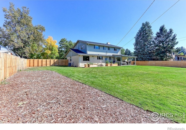 11230 W 77th Dr, Arvada, CO 80005 - back of house with a fenced backyard and a patio