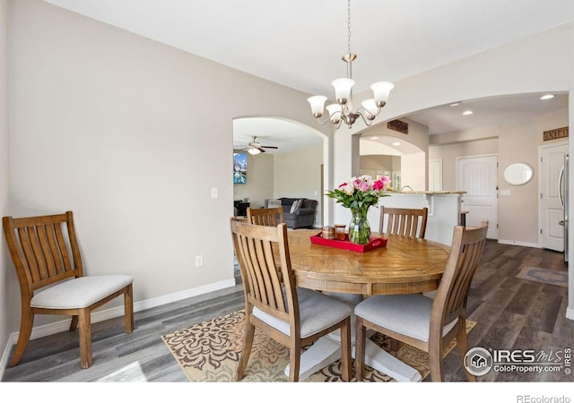 1705 Wales Dr, Berthoud, CO 80513 - dining room featuring dark wood-style floors, arched walkways, a chandelier, a ceiling fan, and recessed lighting