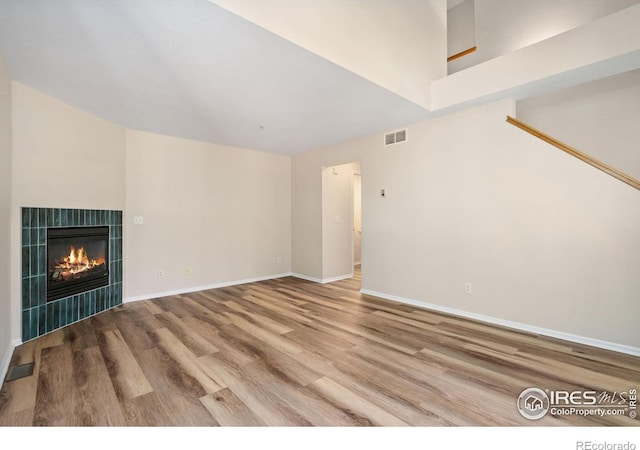2702 Rigden Pkwy Unit F4, Fort Collins, CO 80525 - unfurnished living room featuring wood finished floors and a tiled fireplace