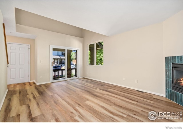 2702 Rigden Pkwy Unit F4, Fort Collins, CO 80525 - unfurnished living room featuring light wood-style flooring and a fireplace