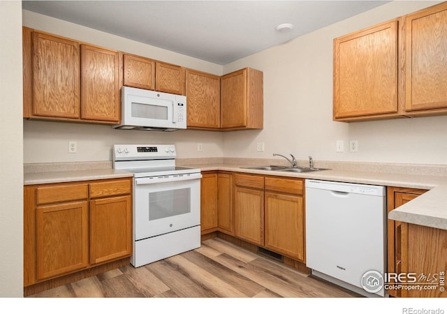 2702 Rigden Pkwy Unit F4, Fort Collins, CO 80525 - kitchen featuring white appliances, light wood finished floors, light countertops, and brown cabinetry