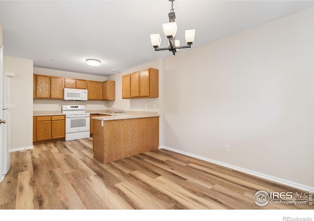 2702 Rigden Pkwy Unit F4, Fort Collins, CO 80525 - kitchen with white appliances, light wood-type flooring, a peninsula, and light countertops