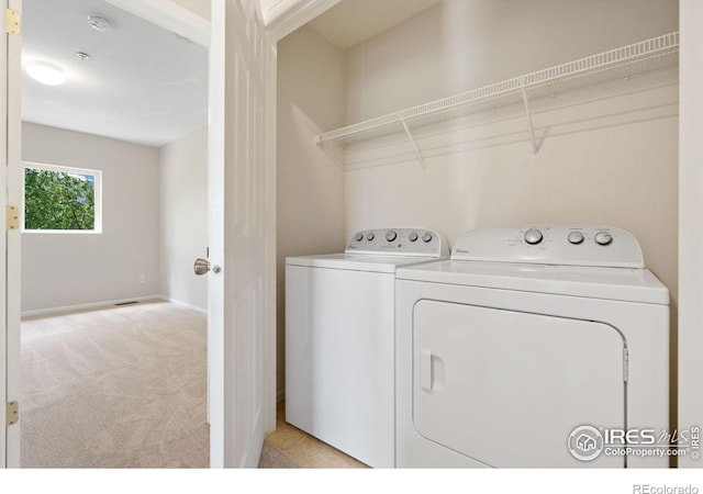 2702 Rigden Pkwy Unit F4, Fort Collins, CO 80525 - laundry area with washing machine and clothes dryer and light colored carpet