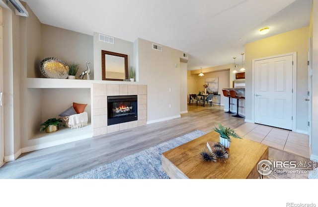 2133 Krisron Rd Unit D103, Fort Collins, CO 80525 - living area featuring a tile fireplace and wood finished floors