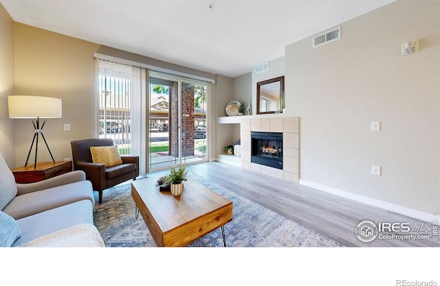 2133 Krisron Rd Unit D103, Fort Collins, CO 80525 - living room featuring wood finished floors and a tiled fireplace