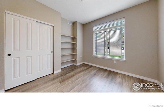 2133 Krisron Rd Unit D103, Fort Collins, CO 80525 - unfurnished bedroom featuring wood finished floors and a closet