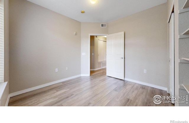 2133 Krisron Rd Unit D103, Fort Collins, CO 80525 - unfurnished bedroom with wood finished floors and a closet