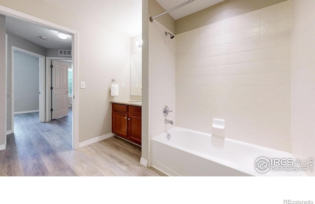 2133 Krisron Rd Unit D103, Fort Collins, CO 80525 - full bathroom featuring wood finished floors, vanity, and washtub / shower combination