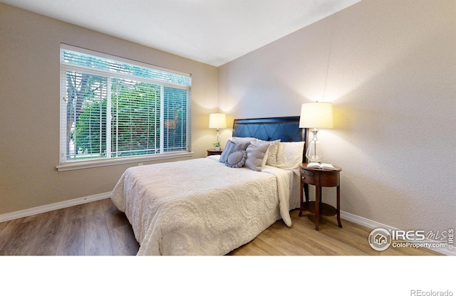 2133 Krisron Rd Unit D103, Fort Collins, CO 80525 - bedroom with baseboards and wood finished floors
