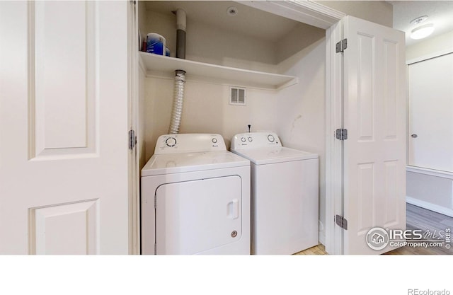 2133 Krisron Rd Unit D103, Fort Collins, CO 80525 - washroom with washing machine and clothes dryer and wood finished floors