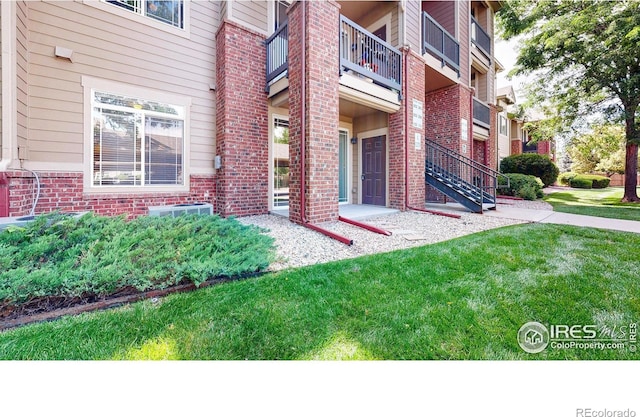 2133 Krisron Rd Unit D103, Fort Collins, CO 80525 - view of exterior entry featuring brick siding and a balcony