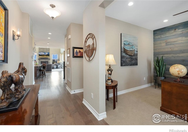 3304 Heron Lakes Pkwy, Berthoud, CO 80513 - corridor featuring recessed lighting, wood walls, and wood finished floors