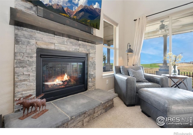 3304 Heron Lakes Pkwy, Berthoud, CO 80513 - living room featuring a fireplace, carpet, and ceiling fan
