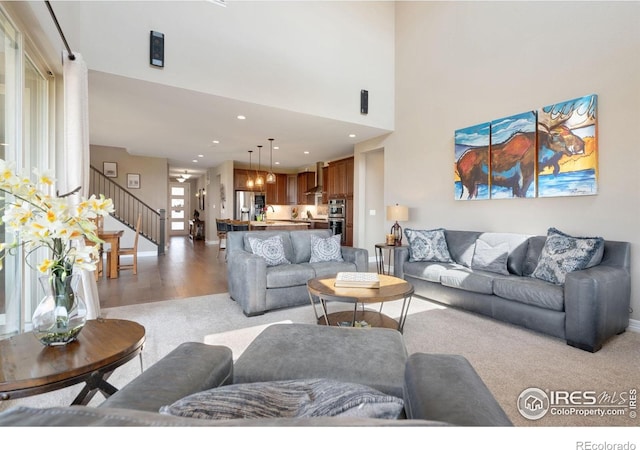 3304 Heron Lakes Pkwy, Berthoud, CO 80513 - living area featuring stairs, light carpet, and recessed lighting