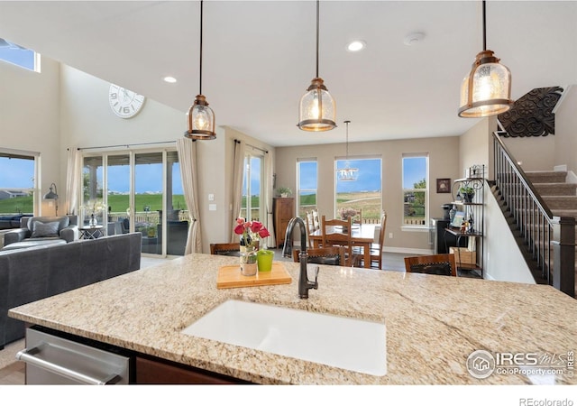 3304 Heron Lakes Pkwy, Berthoud, CO 80513 - kitchen with open floor plan, recessed lighting, light stone countertops, and pendant lighting