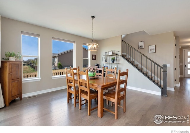 3304 Heron Lakes Pkwy, Berthoud, CO 80513 - dining room with a chandelier, stairway, and light wood finished floors
