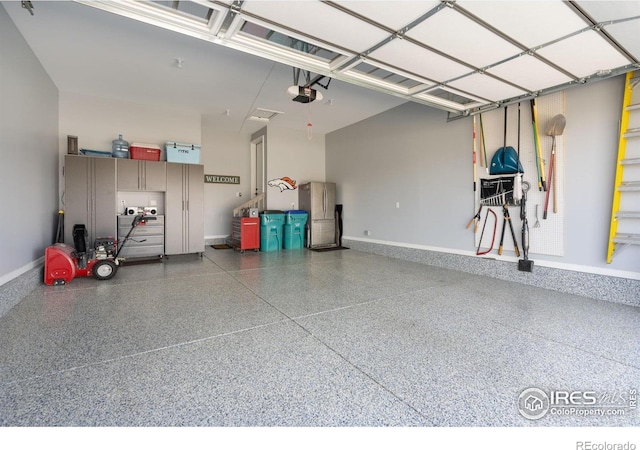 3304 Heron Lakes Pkwy, Berthoud, CO 80513 - garage with baseboards and a garage door opener