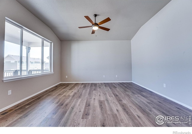604 Rosedale St, Severance, CO 80550 - spare room with vaulted ceiling, a ceiling fan, and wood finished floors