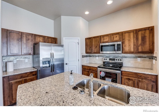 604 Rosedale St, Severance, CO 80550 - kitchen featuring stainless steel appliances, decorative backsplash, light stone counters, and recessed lighting