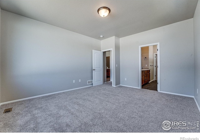 604 Rosedale St, Severance, CO 80550 - unfurnished bedroom with dark colored carpet and ensuite bathroom