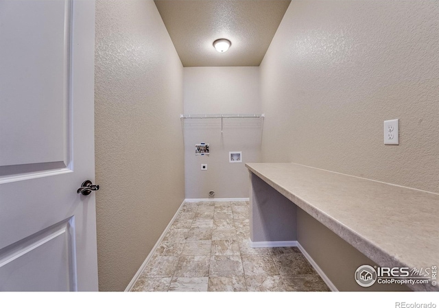 604 Rosedale St, Severance, CO 80550 - laundry area featuring hookup for a washing machine, hookup for an electric dryer, light stone finish floors, and a textured wall