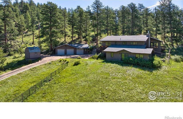 2160 Devils Gulch Rd, Estes Park, CO 80517 - view of front of property featuring a detached garage, an outdoor structure, a chimney, and a view of trees