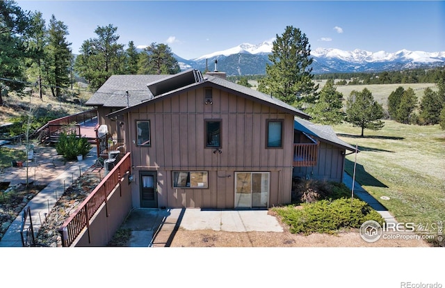 2160 Devils Gulch Rd, Estes Park, CO 80517 - view of front of property featuring stairs, board and batten siding, a chimney, and roof with shingles