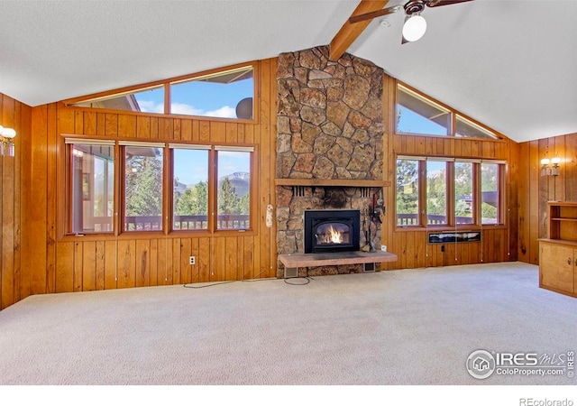 2160 Devils Gulch Rd, Estes Park, CO 80517 - unfurnished living room featuring carpet floors, wooden walls, ceiling fan, and a fireplace
