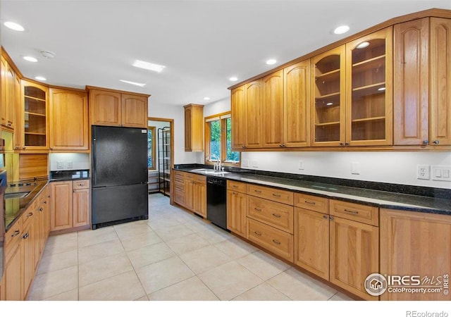 2160 Devils Gulch Rd, Estes Park, CO 80517 - kitchen with black appliances, recessed lighting, glass insert cabinets, brown cabinetry, and light tile patterned floors