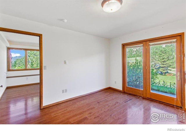 2160 Devils Gulch Rd, Estes Park, CO 80517 - spare room featuring plenty of natural light and wood finished floors