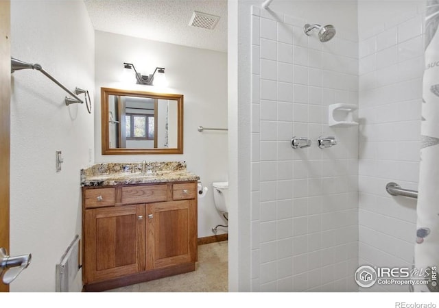2160 Devils Gulch Rd, Estes Park, CO 80517 - full bathroom featuring vanity, tiled shower, and a textured ceiling