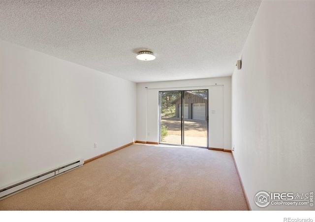 2160 Devils Gulch Rd, Estes Park, CO 80517 - carpeted empty room featuring a baseboard heating unit and a textured ceiling