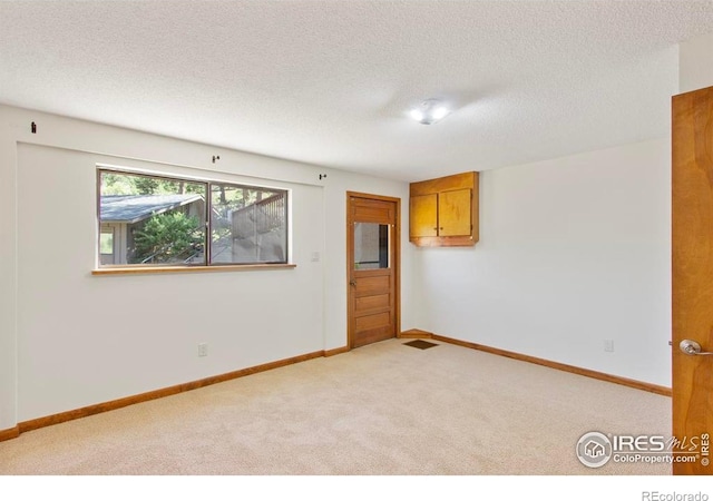 2160 Devils Gulch Rd, Estes Park, CO 80517 - spare room featuring light colored carpet and a textured ceiling