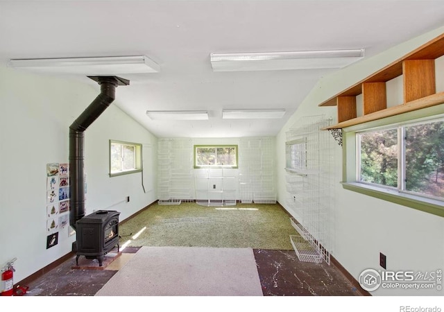 2160 Devils Gulch Rd, Estes Park, CO 80517 - unfurnished living room featuring a wood stove and vaulted ceiling
