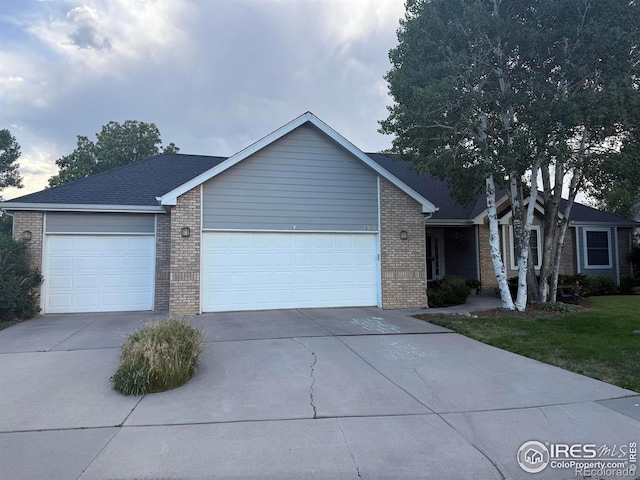 1460 Hawkridge Rd, Eaton, CO 80615 - ranch-style house featuring brick siding, a garage, and driveway