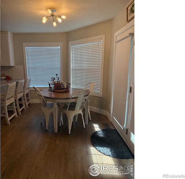 1460 Hawkridge Rd, Eaton, CO 80615 - dining room featuring wood finished floors, a textured ceiling, and a chandelier