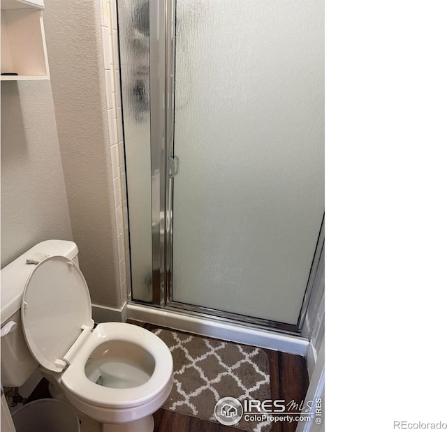 1460 Hawkridge Rd, Eaton, CO 80615 - full bathroom with a stall shower, wood finished floors, and a textured wall