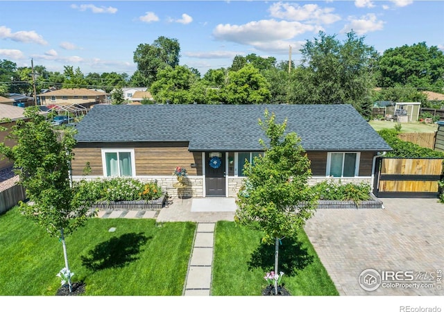 7131 Pontiac St, Commerce City, CO 80022 - view of front of house with stone siding and a shingled roof