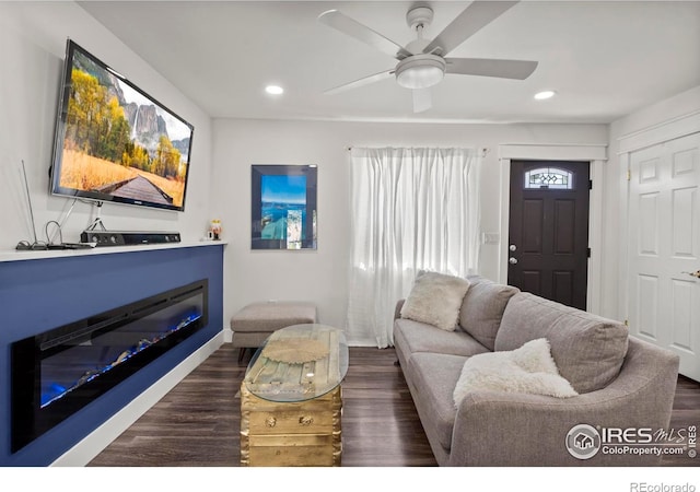 7131 Pontiac St, Commerce City, CO 80022 - living room with a glass covered fireplace, recessed lighting, dark wood-style floors, and ceiling fan