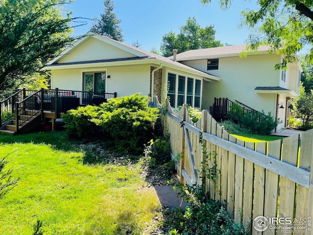 4303 30th St, Boulder, CO 80301 - back of property with a wooden deck, stucco siding, and stairs