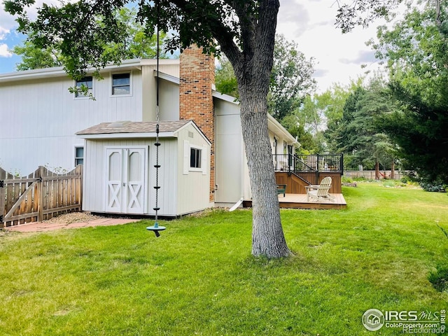 4303 30th St, Boulder, CO 80301 - back of house featuring a wooden deck, a fenced backyard, a chimney, and a storage unit